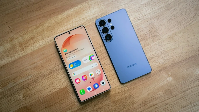 Two smartphones displayed on a wooden surface.